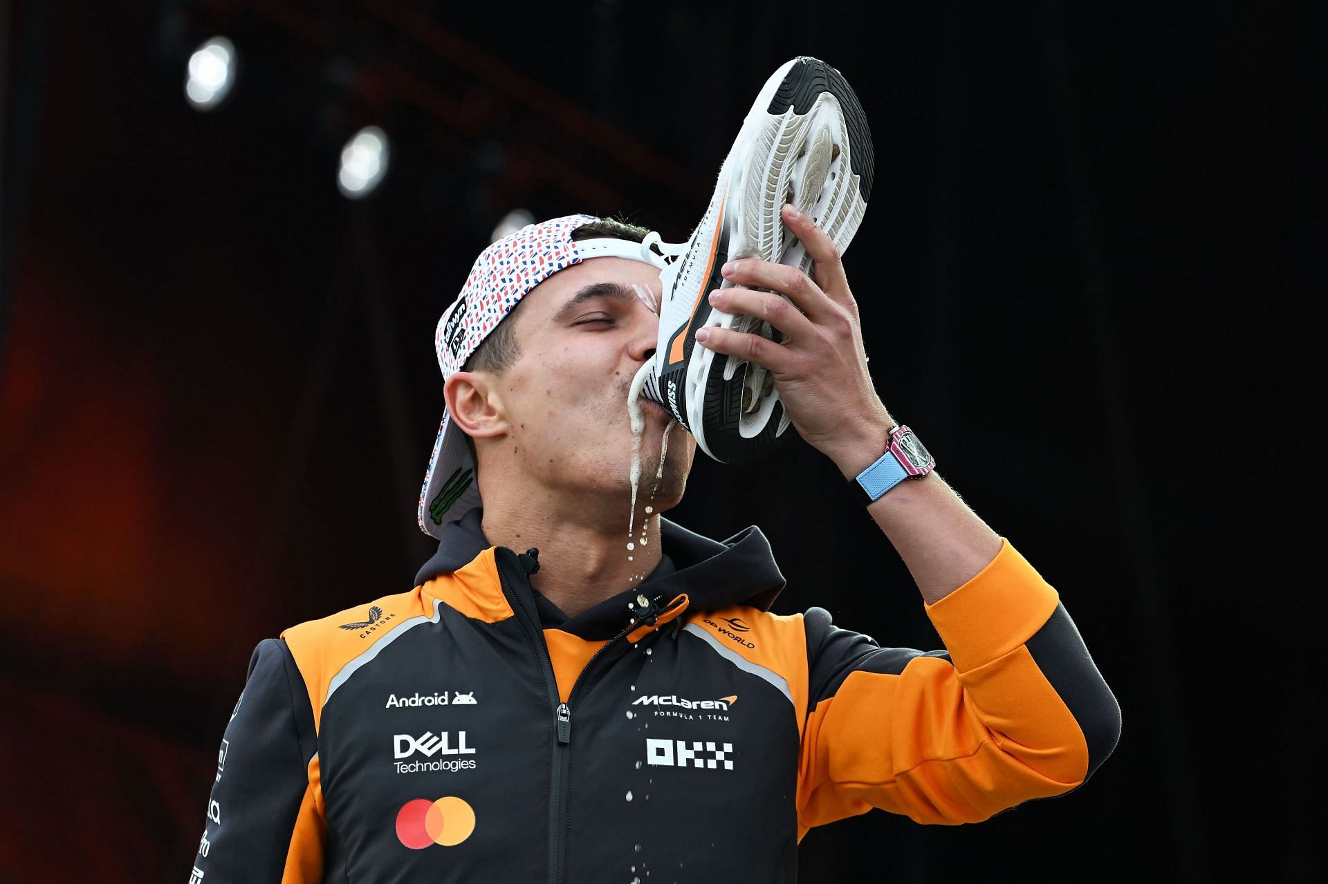 Lando Norris does a shoey on the Silverstone fan stage to celebrate his win - Source: Getty
